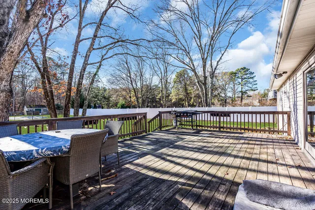 a view of a house with a big yard and large trees