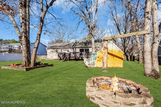 a white bench sitting in the middle of a park
