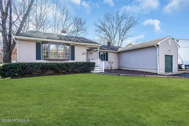 a front view of house with yard and green space