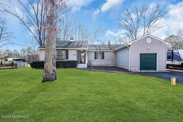 a front view of house with yard and green space