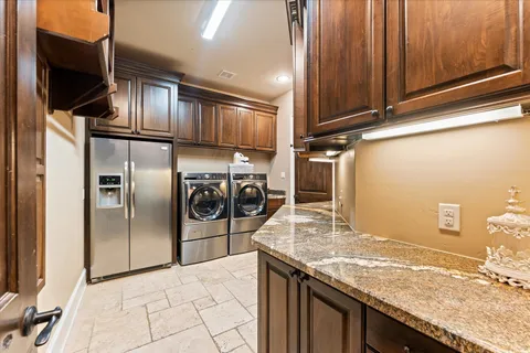 a bathroom with a granite countertop toilet sink and mirror