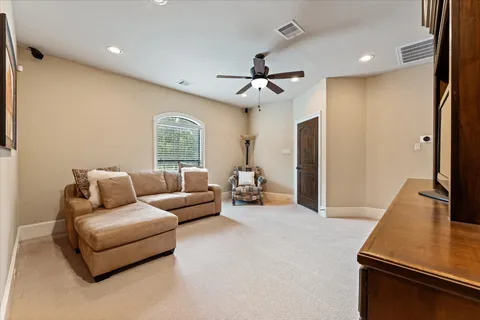 a bedroom with a bed a fireplace and dresser
