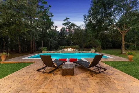 a view of a patio with couches under an umbrella