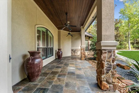 a view of a porch with chairs and a yard