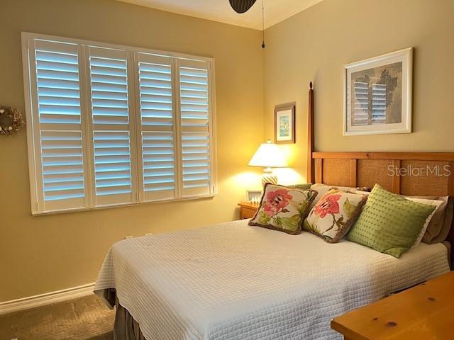 2060 Matecumbe Key Road, Unit 2104 Punta Gorda, FL 33955 - Photo 17 of 44 a bedroom with a bed and a night stand