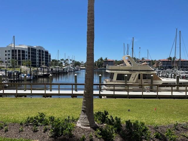 2060 Matecumbe Key Road, Unit 2104 Punta Gorda, FL 33955 - Photo 8 of 44 a view of a lake with lawn chairs and a table