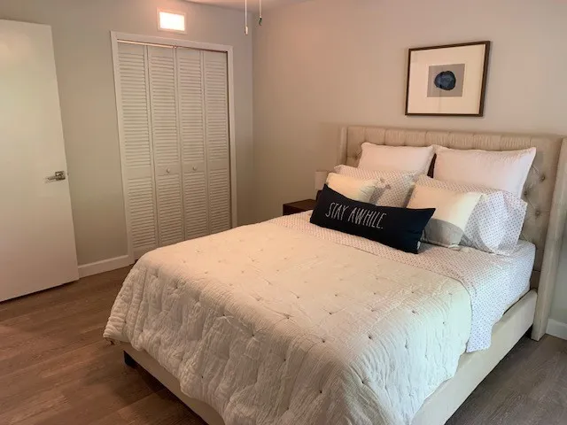 a bedroom with a bed and a night stand