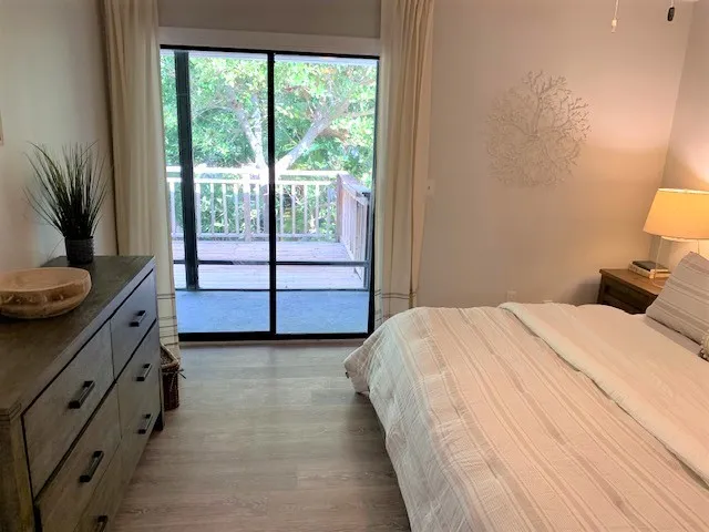 a spacious bedroom with a bed and a window