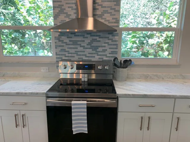 a stove top oven sitting inside of a kitchen