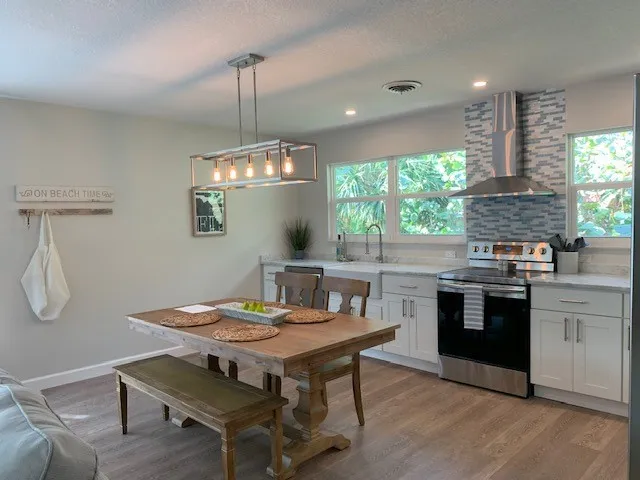 a kitchen with a table and chairs in it