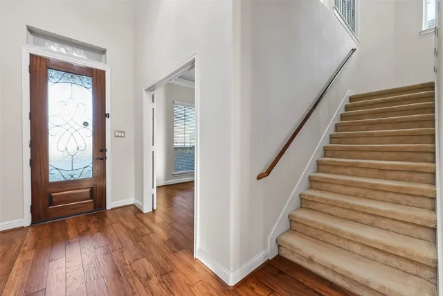 a view of an empty room with wooden floor