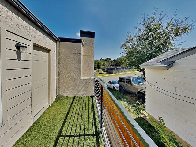 a balcony with view of nearby houses