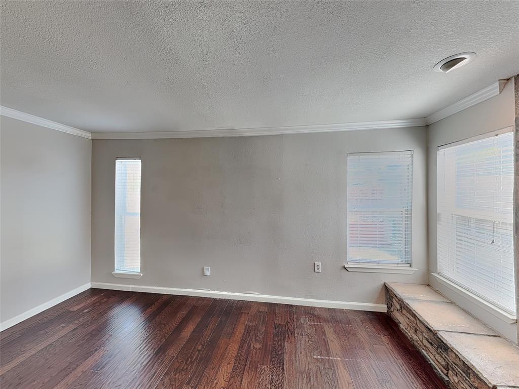 2201 Park Hill Drive Fort Worth, TX 76110 - Photo 3 of 14 an empty room with wooden floor and windows
