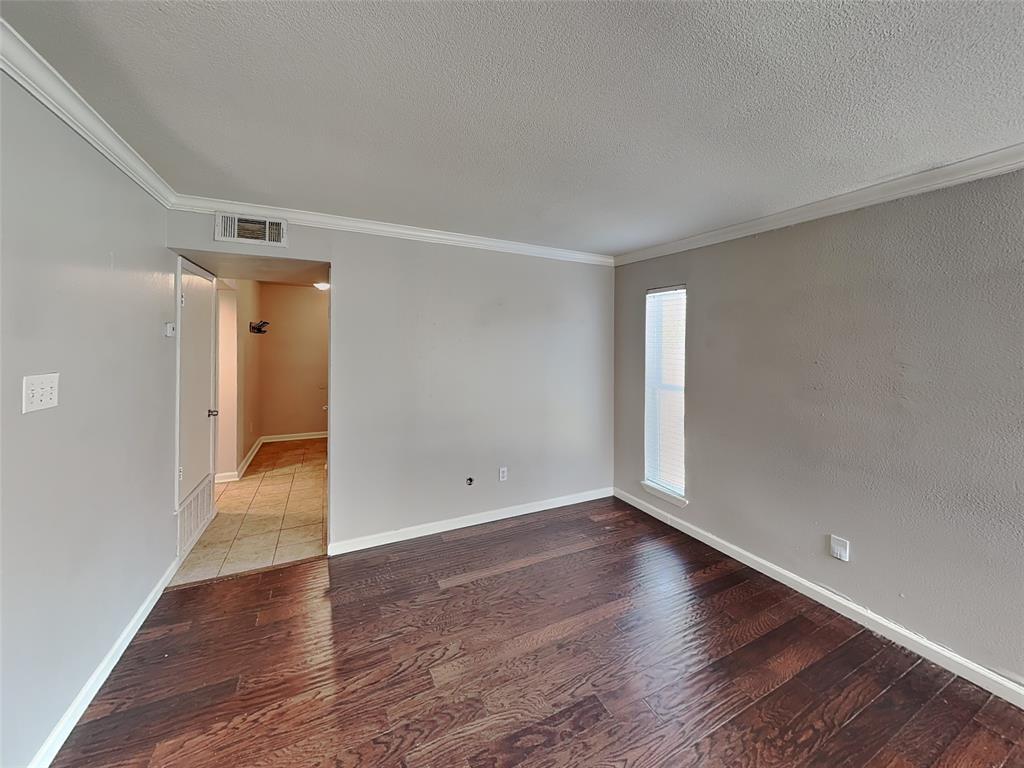 2201 Park Hill Drive Fort Worth, TX 76110 - Photo 4 of 14 a view of an empty room with wooden floor