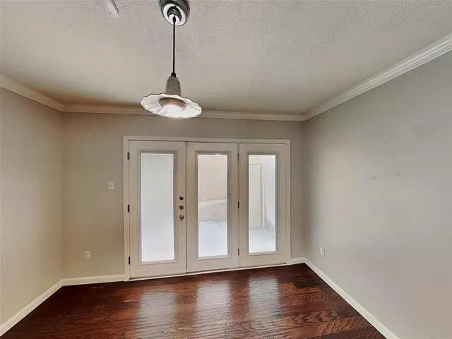 a view of empty room with wooden floor and window
