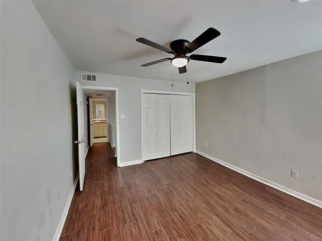 a view of an empty room and wooden floor