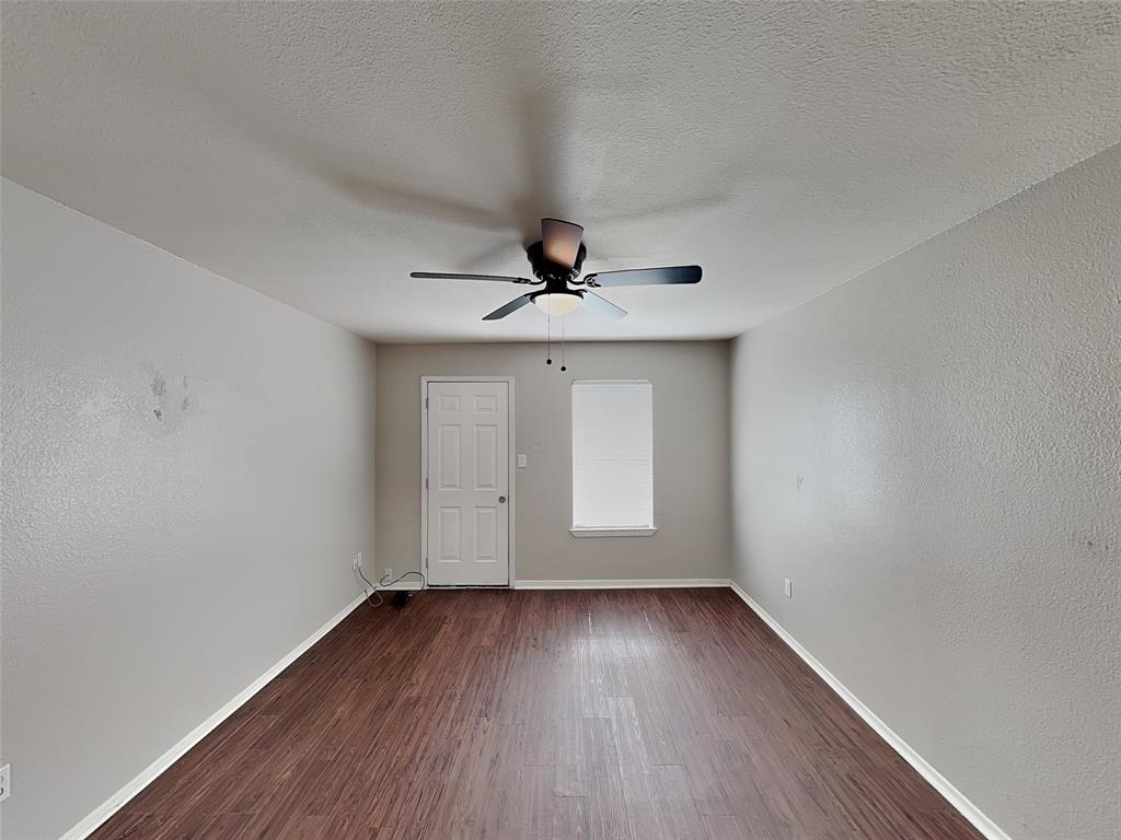 2201 Park Hill Drive Fort Worth, TX 76110 - Photo 9 of 14 wooden floor in an empty room