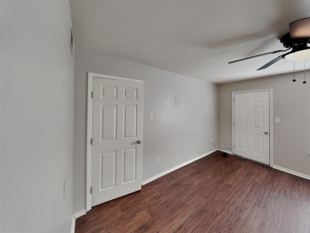 2201 Park Hill Drive Fort Worth, TX 76110 - Photo 10 of 14 a view of an empty room with wooden floor