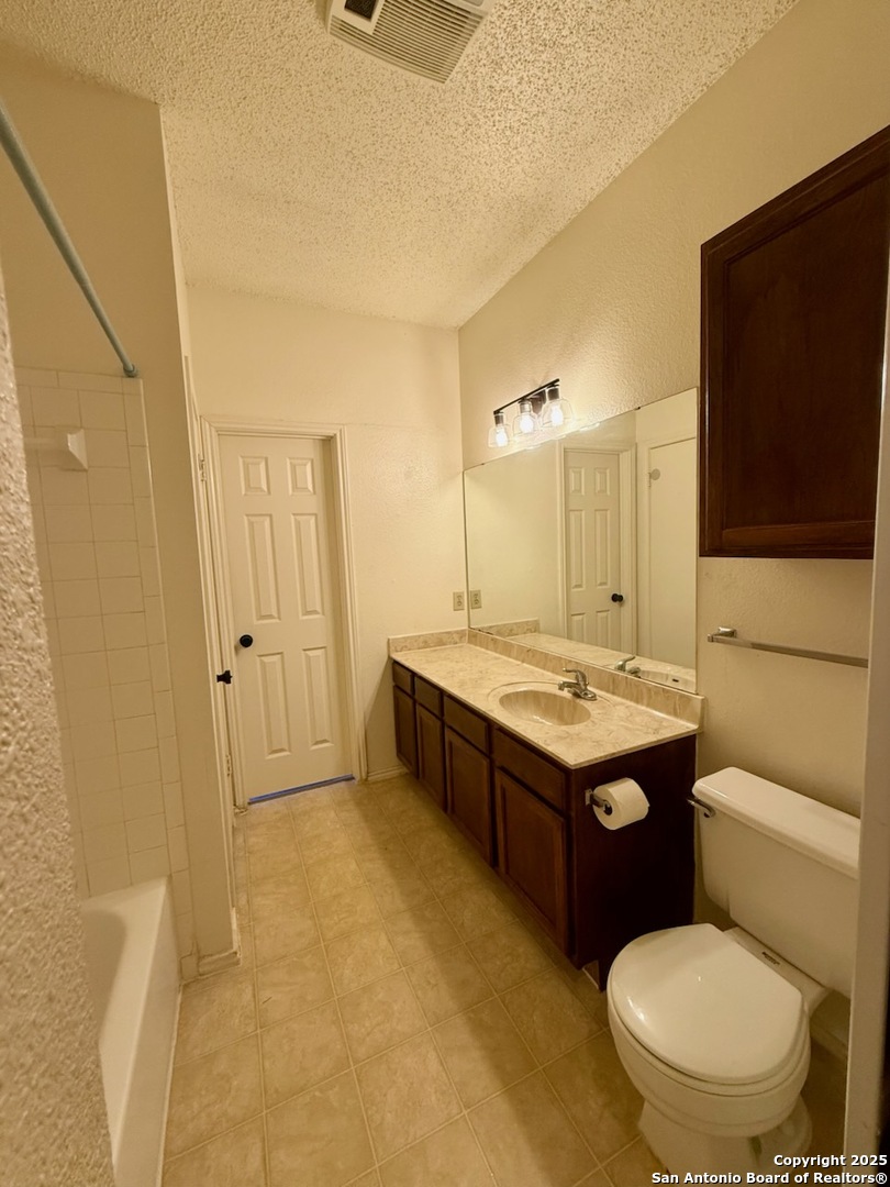 3420 Ridge Smoke San Antonio, TX 78247 - Photo 13 of 20 a bathroom with a granite countertop toilet sink and mirror