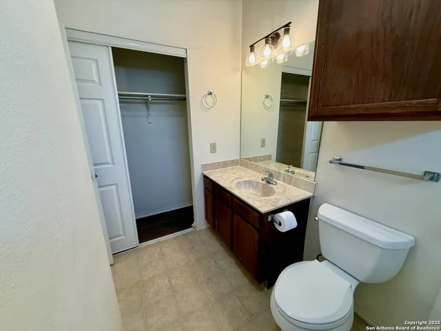 a bathroom with a toilet a sink and vanity