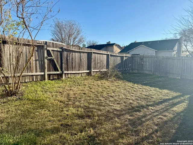 a house view with wooden fence