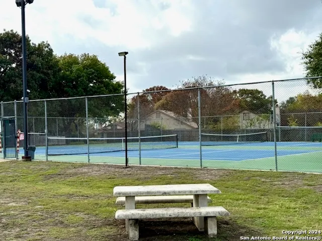a view of a park with iron fence