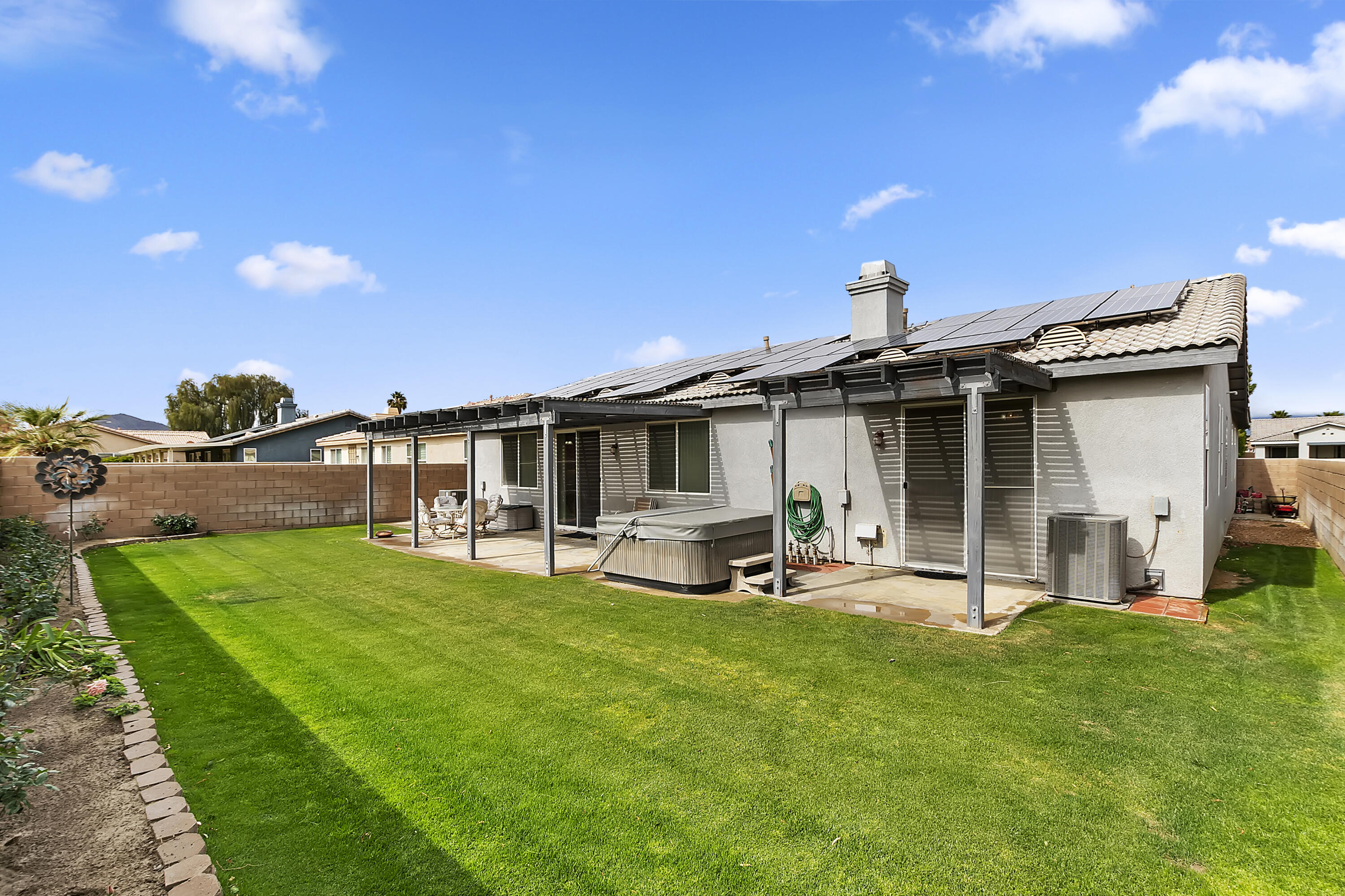 80733 Diamondback Trail Indio, CA 92201 - Photo 15 of 16 a view of a house with backyard porch and sitting area