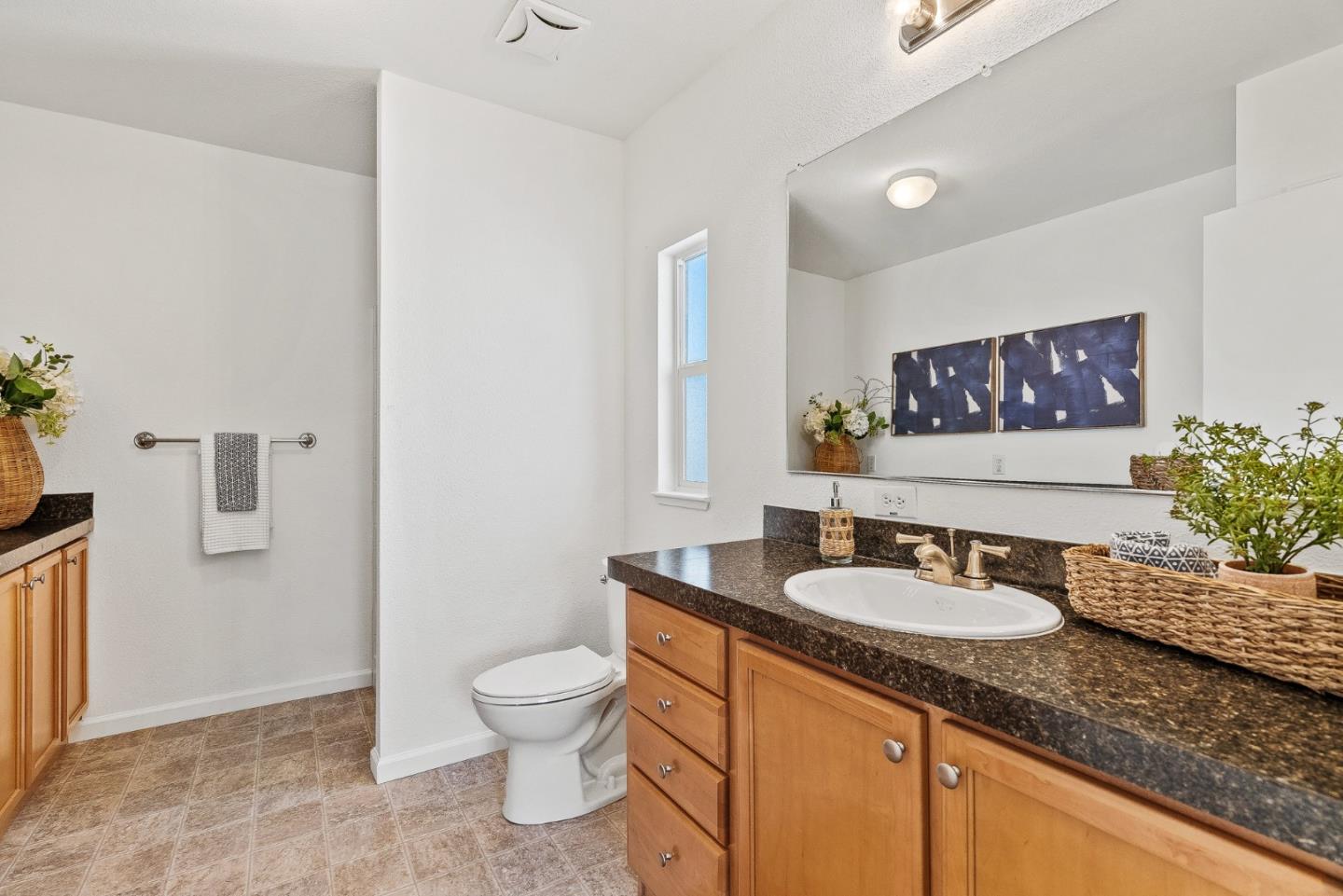 4160 Jade Street, Unit 90 Capitola, CA 95010 - Photo 12 of 18 a bathroom with a granite countertop sink a toilet and a mirror