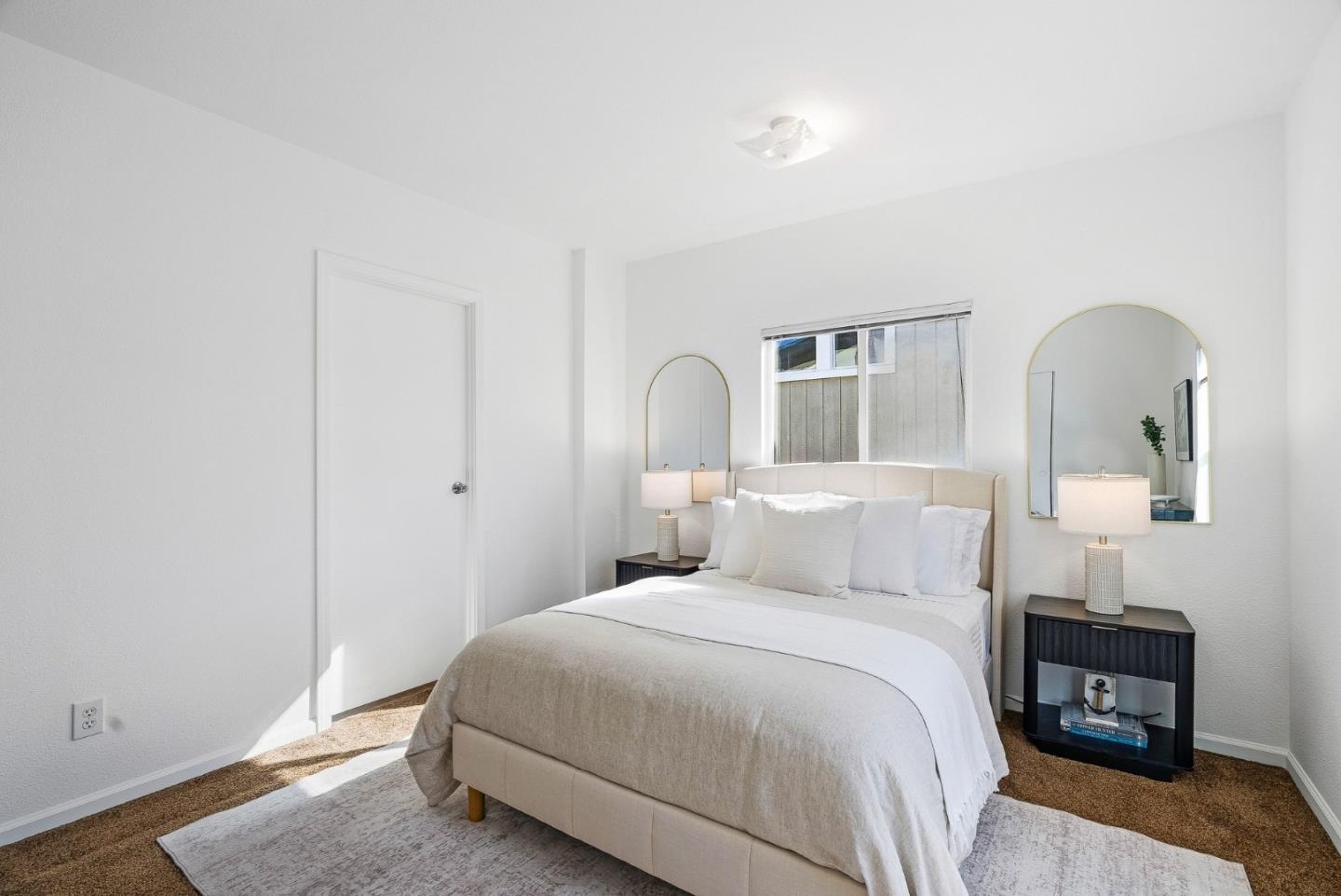 4160 Jade Street, Unit 90 Capitola, CA 95010 - Photo 12 of 18 a bedroom with a bed and a night stand