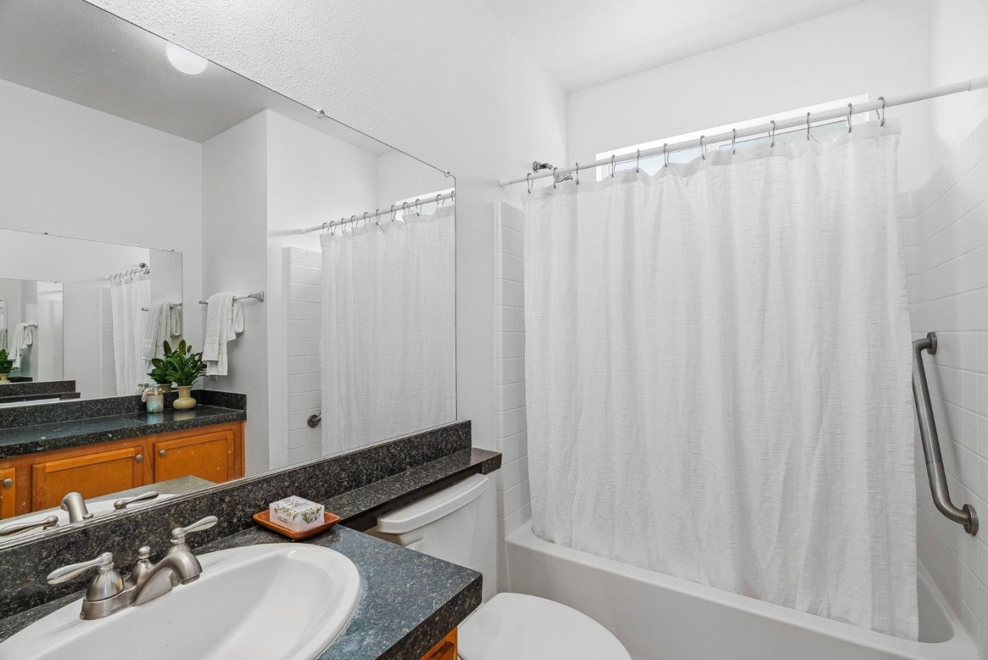 4160 Jade Street, Unit 90 Capitola, CA 95010 - Photo 13 of 18 a bathroom with a sink toilet and shower