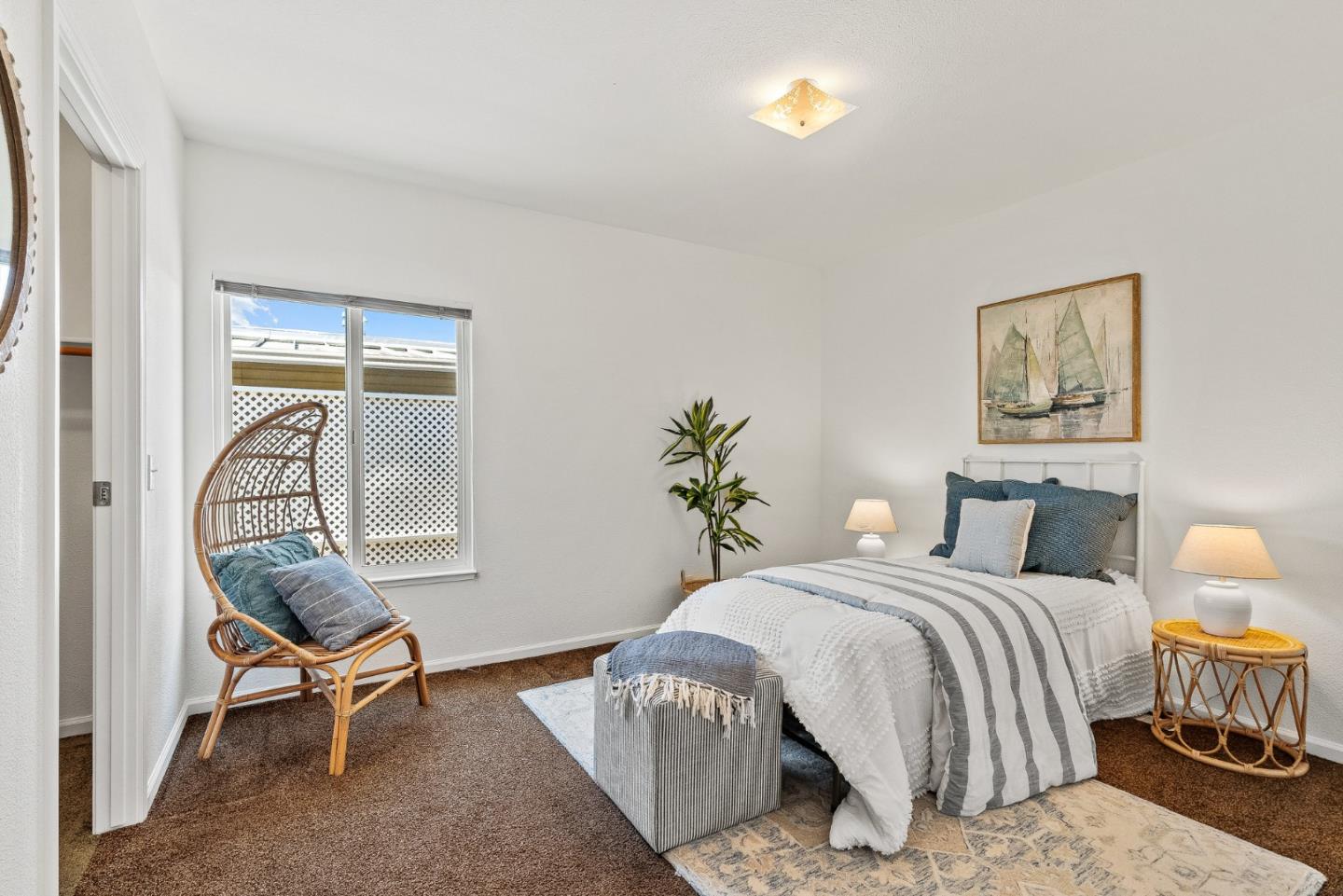 4160 Jade Street, Unit 90 Capitola, CA 95010 - Photo 14 of 18 a bedroom with a bed and a chair