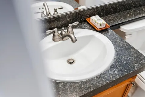a bathroom with a sink and mirror