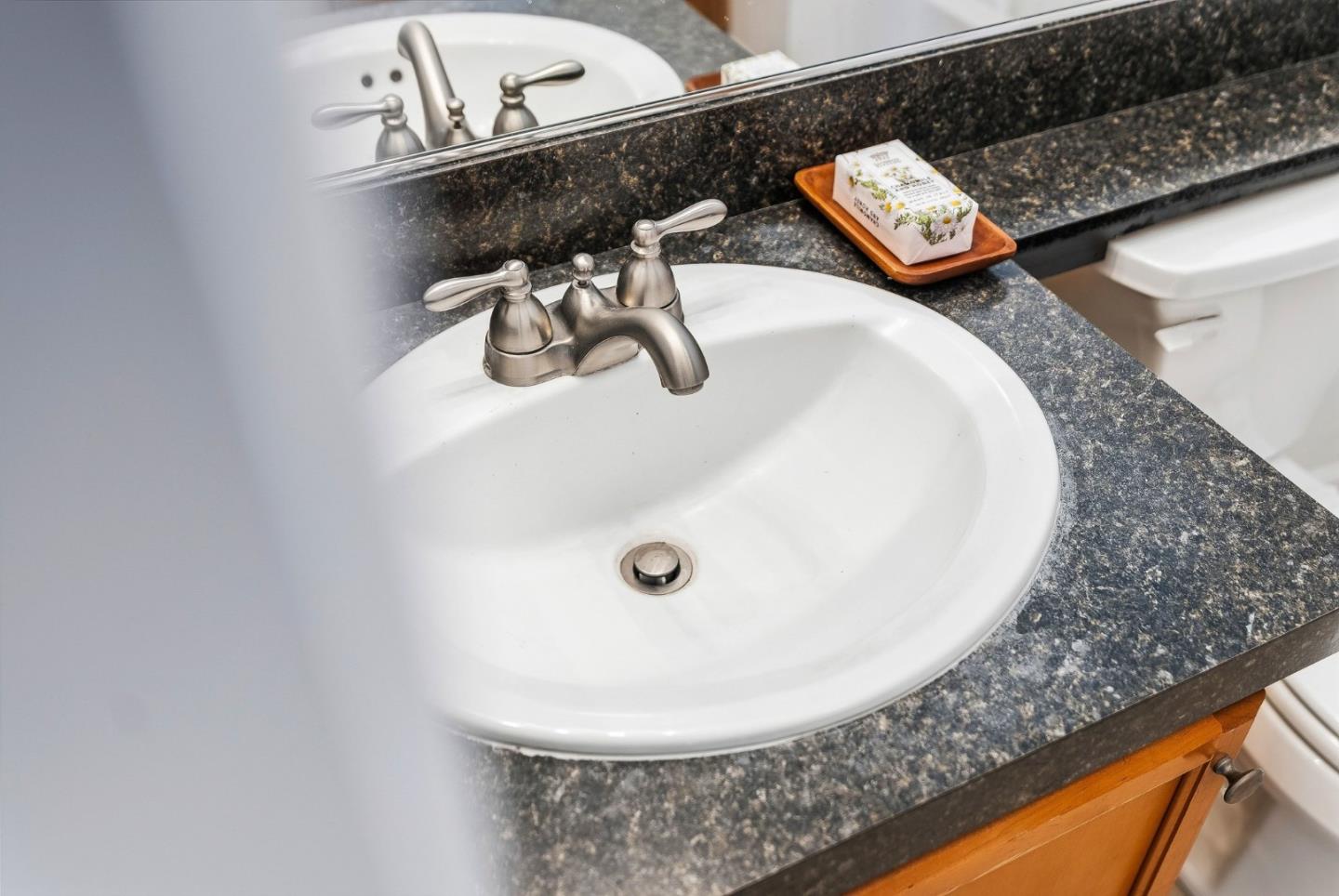 4160 Jade Street, Unit 90 Capitola, CA 95010 - Photo 14 of 18 a bathroom with a sink and mirror