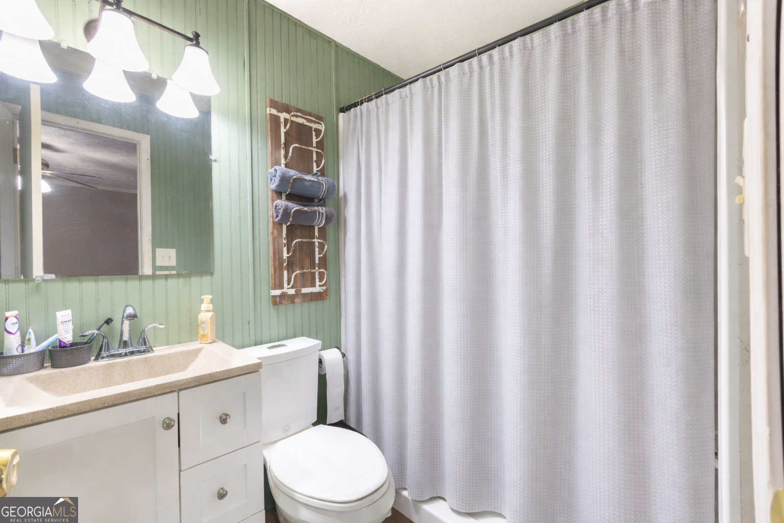 820 County Road 14 Muscadine, AL 36269 - Photo 11 of 20 a bathroom with a sink a toilet and shower curtain