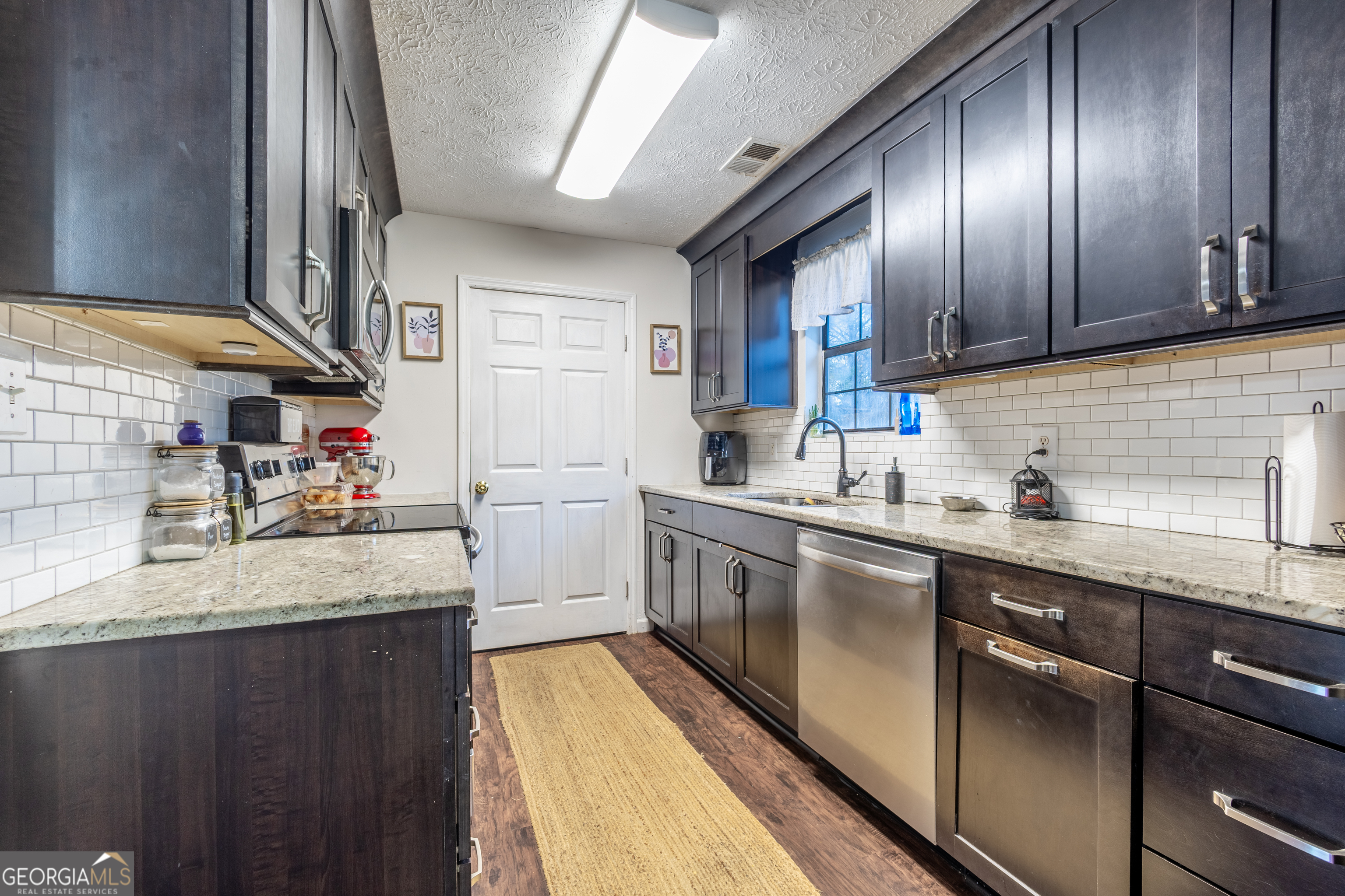 820 County Road 14 Muscadine, AL 36269 - Photo 3 of 20 a kitchen with stainless steel appliances granite countertop wooden cabinets a sink and dishwasher