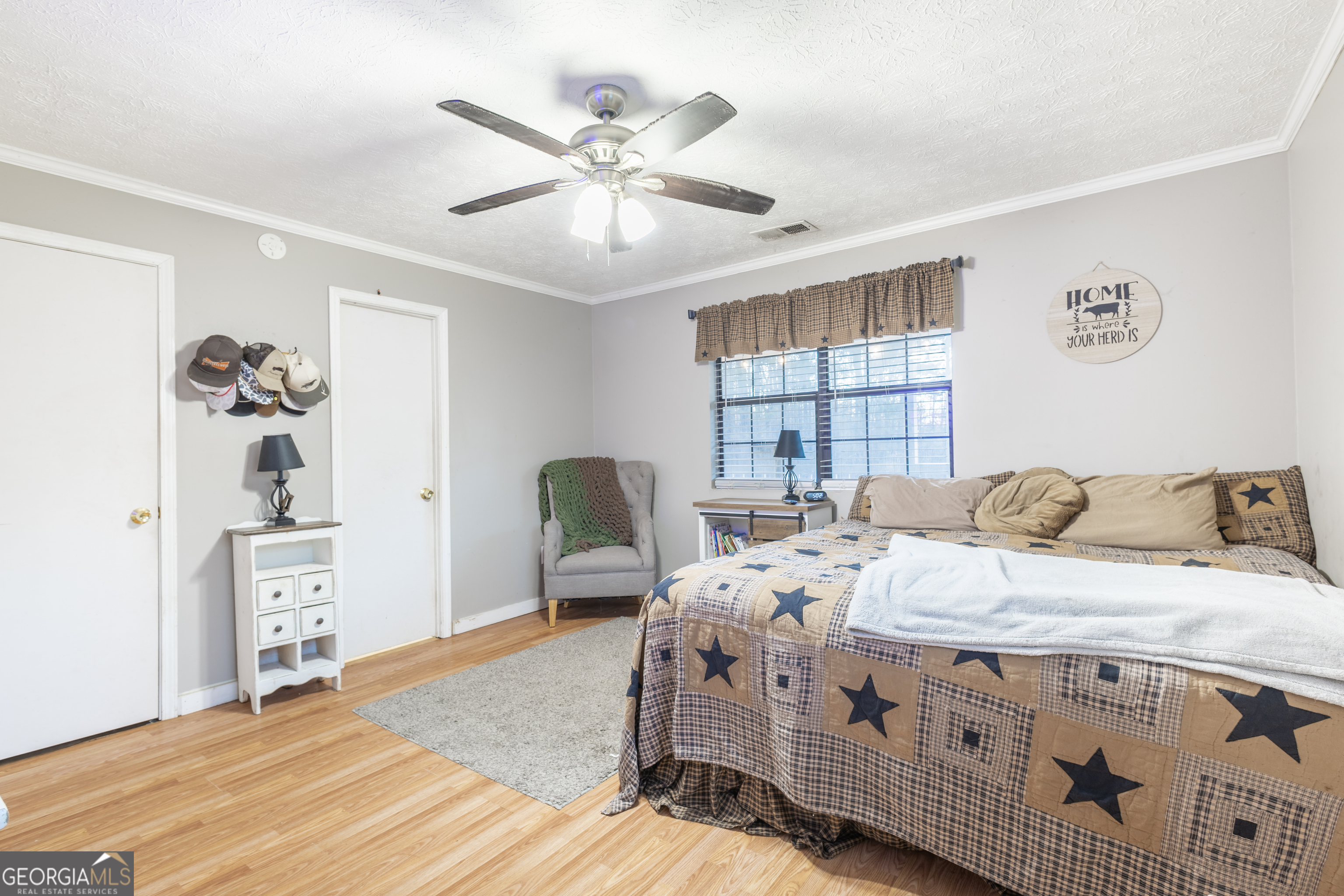 820 County Road 14 Muscadine, AL 36269 - Photo 5 of 20 a bedroom with a bed a dresser and potted plant