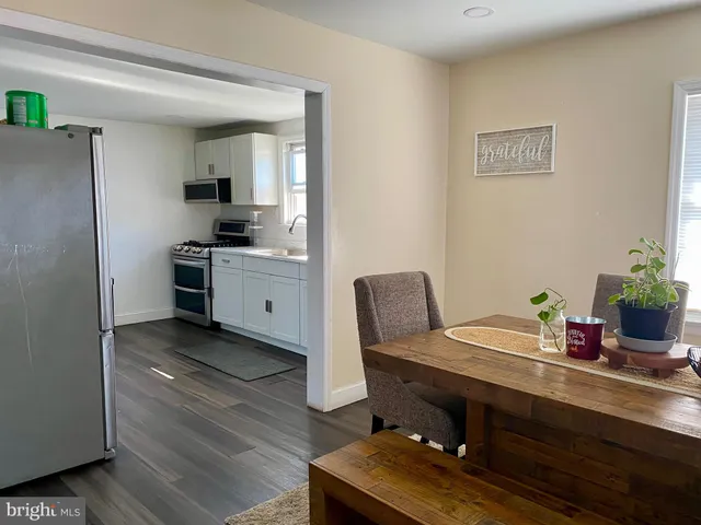 a view of a workspace with furniture and wooden floor