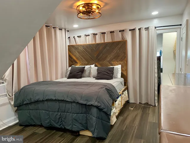 a bedroom with a bed and a chandelier