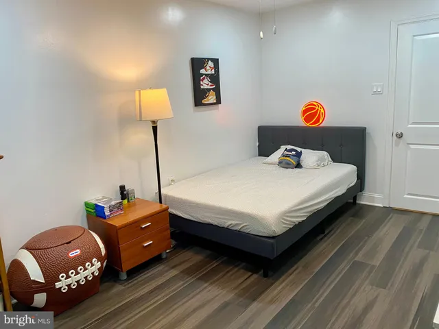 a bed room with a bed and a lamp on desk