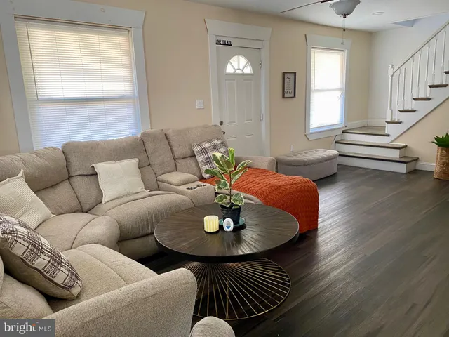 a living room with furniture and a chandelier
