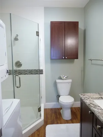 a bathroom with a toilet and a shower
