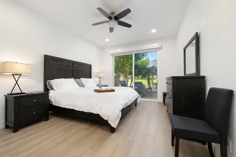 a bed sitting in a bedroom next to a window