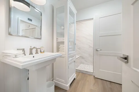 a bathroom with a sink a tub and a mirror