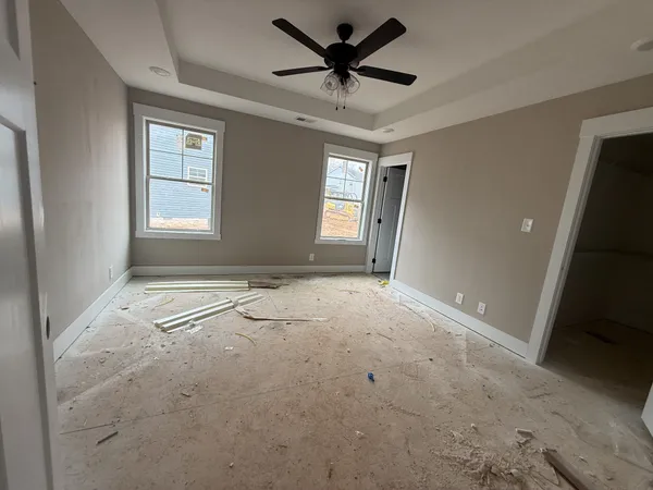 a view of a livingroom with a ceiling fan and window