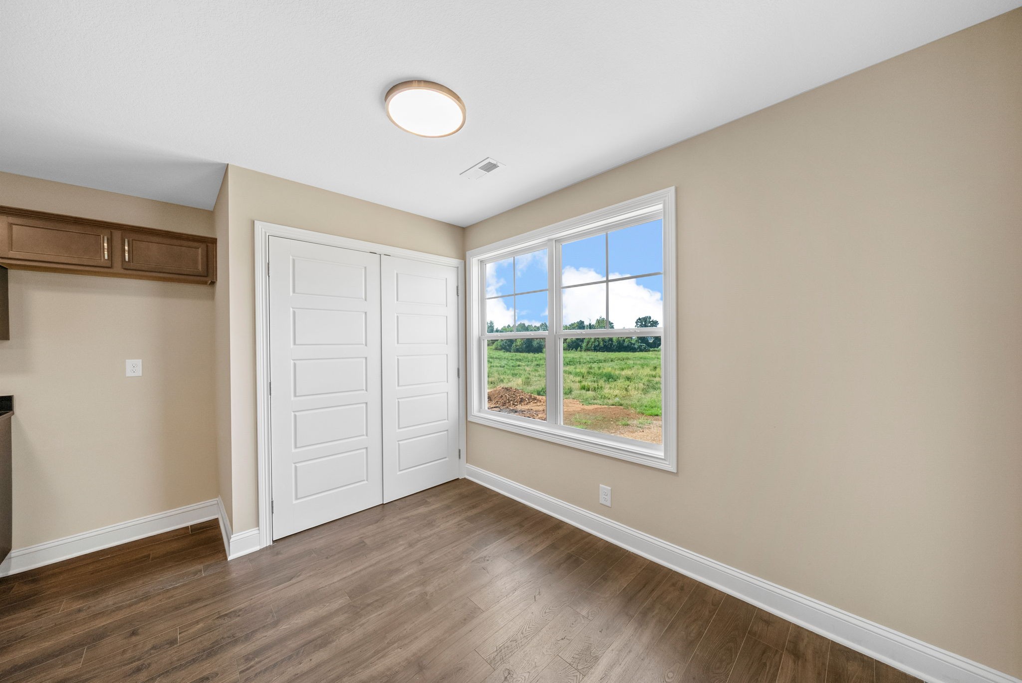 34 Echo Ridge Oak Grove, KY 42262 - Photo 7 of 33 a view of an empty room with wooden floor and a window