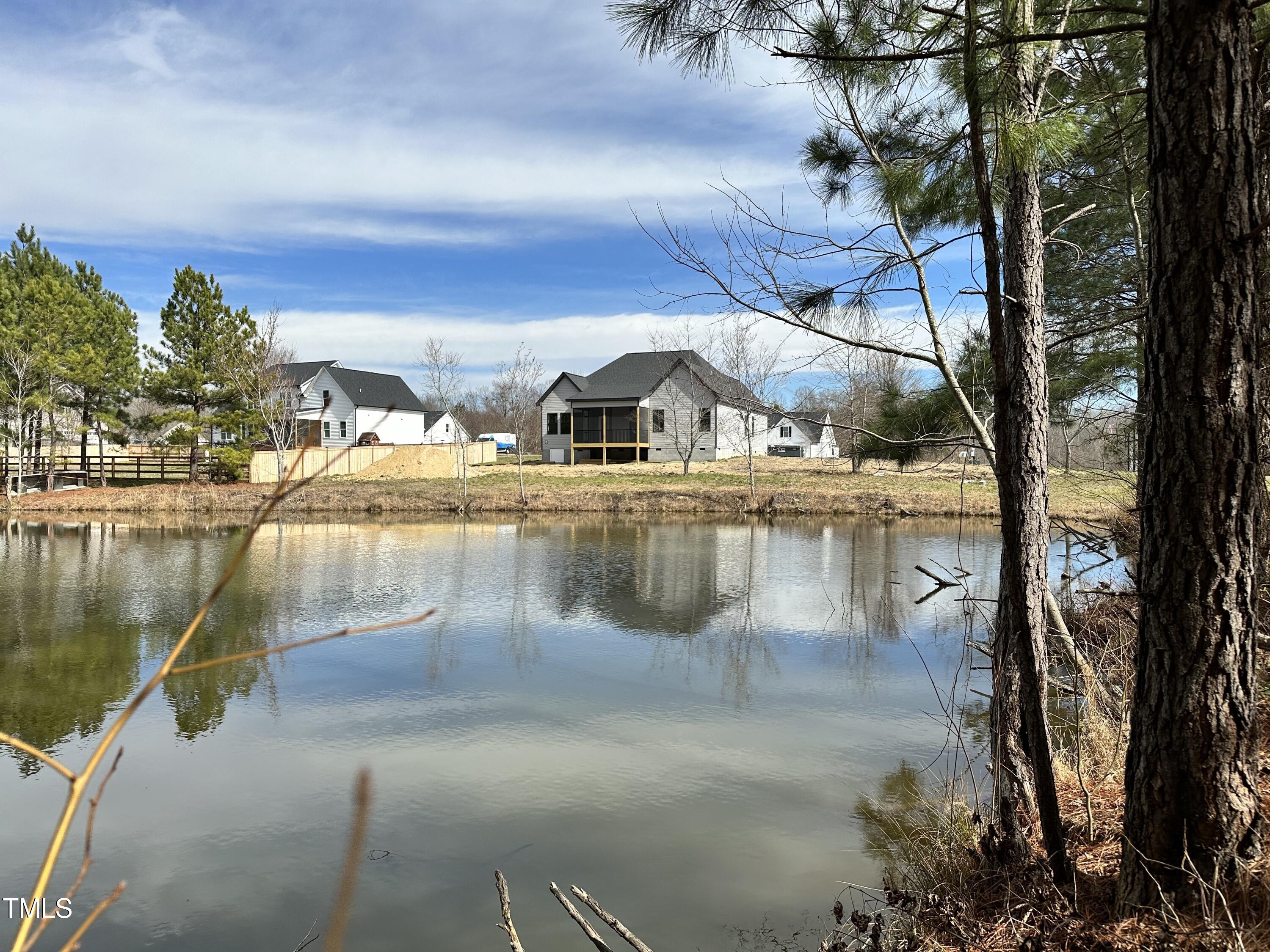 60 Pilot Ridge Road Zebulon, NC 27597 - Photo 5 of 7 a view of a lake with a house in the background