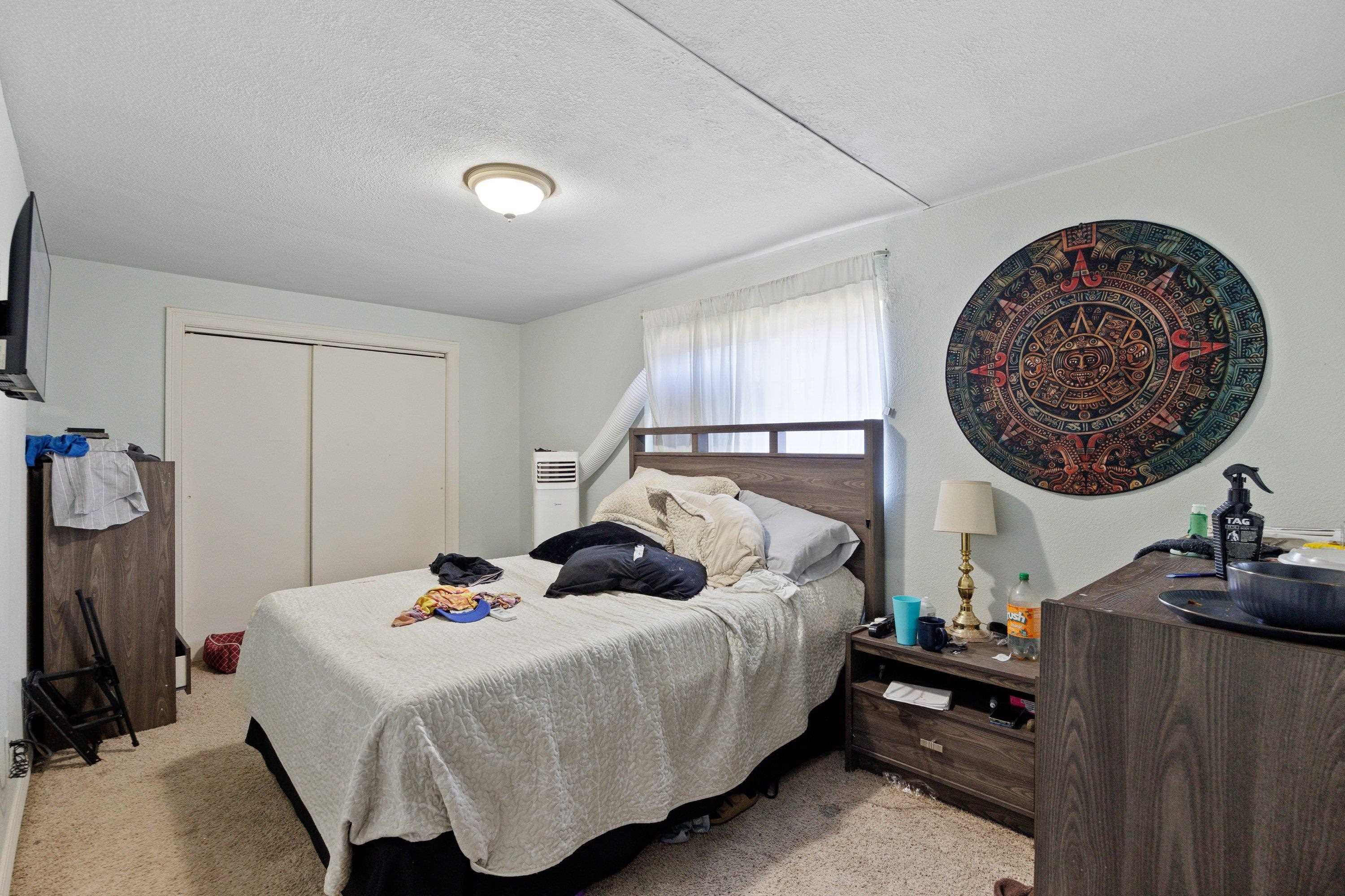 1220 5th Avenue Corning, CA 96021 - Photo 12 of 15 a bedroom with a bed and a lamp on dresser