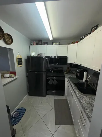 a kitchen with a refrigerator and a stove