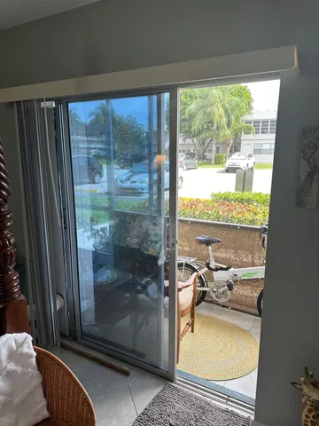 a room with furniture and a floor to ceiling window