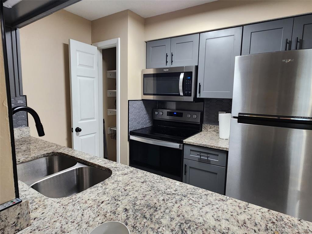 211 Thorntree Place Brandon, FL 33510 - Photo 9 of 16 a kitchen with a refrigerator sink and stainless steel appliances